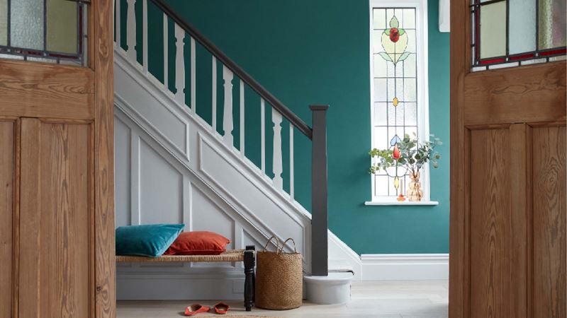 A freshly painted white staircase with black bannister