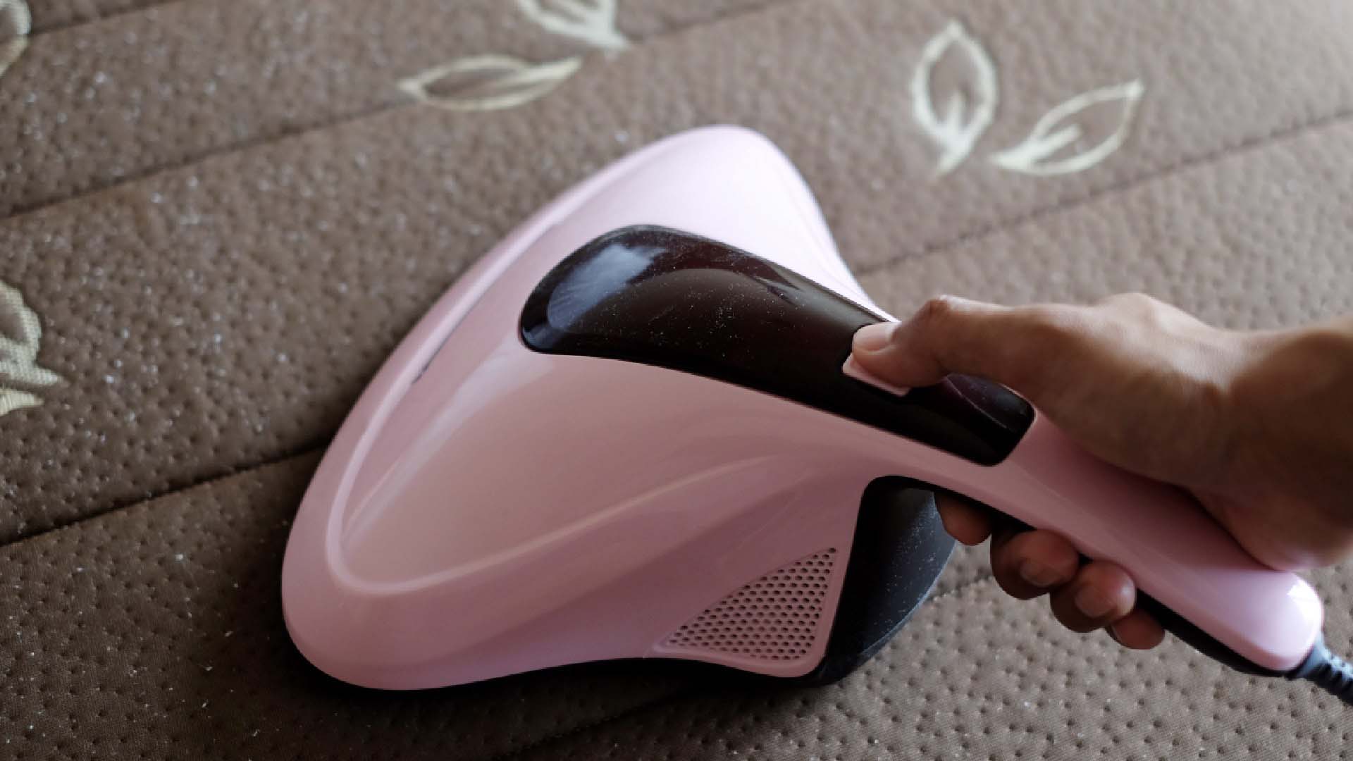 A person vaccuming with a handheld vacuum