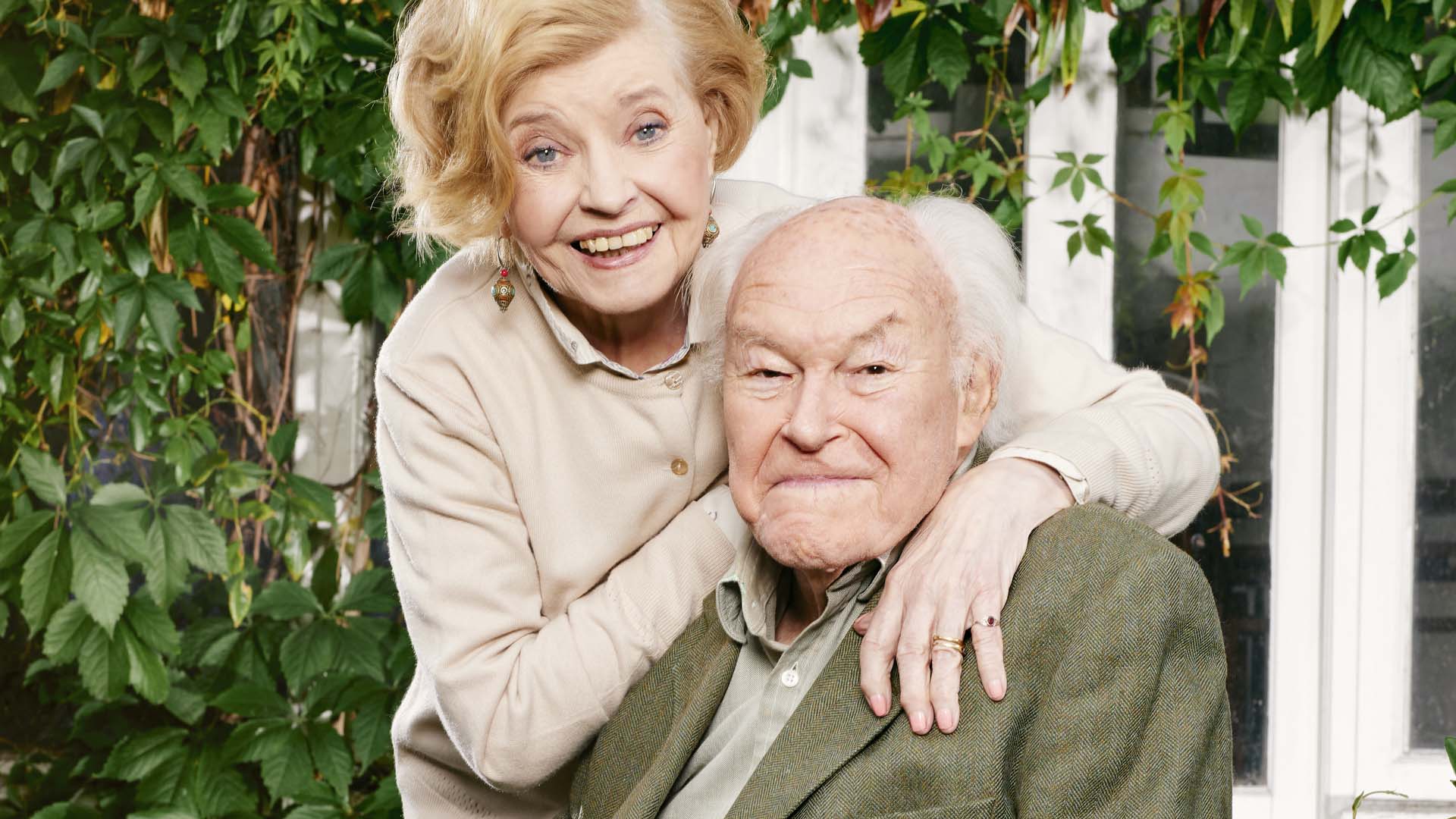 Actor Timothy West with wife Prunella Scales standing behind him