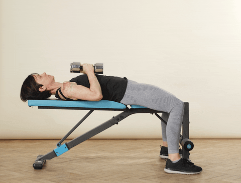 woman doing a dumbbell chest fly