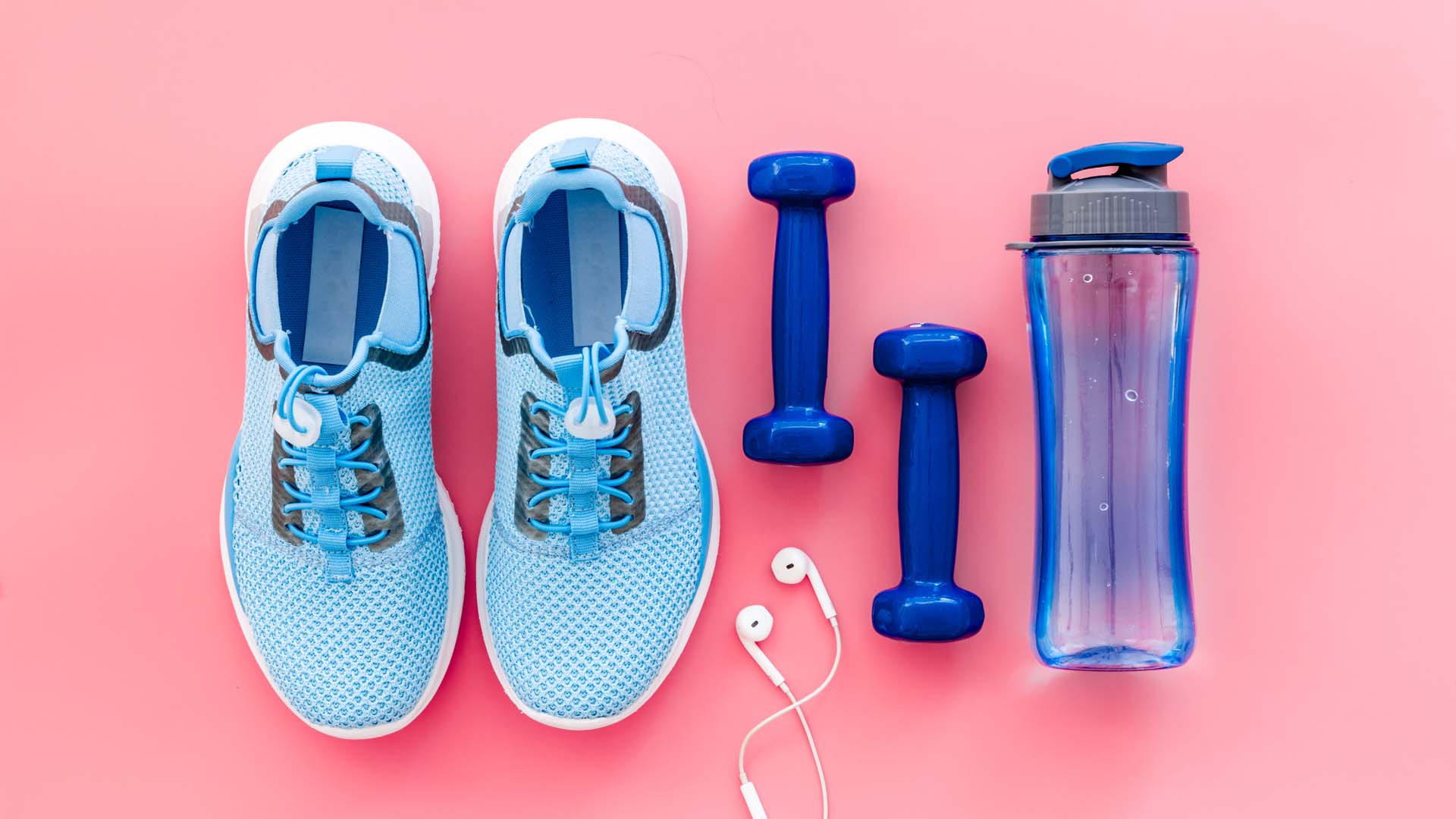 A pair of shoes, weights, a water bottle and earphones
