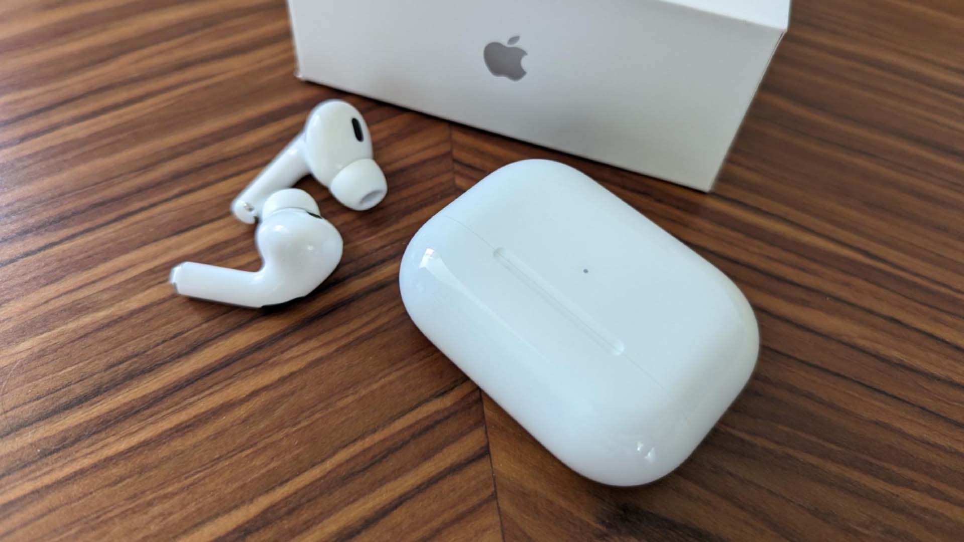 Apple AirPods next to their case