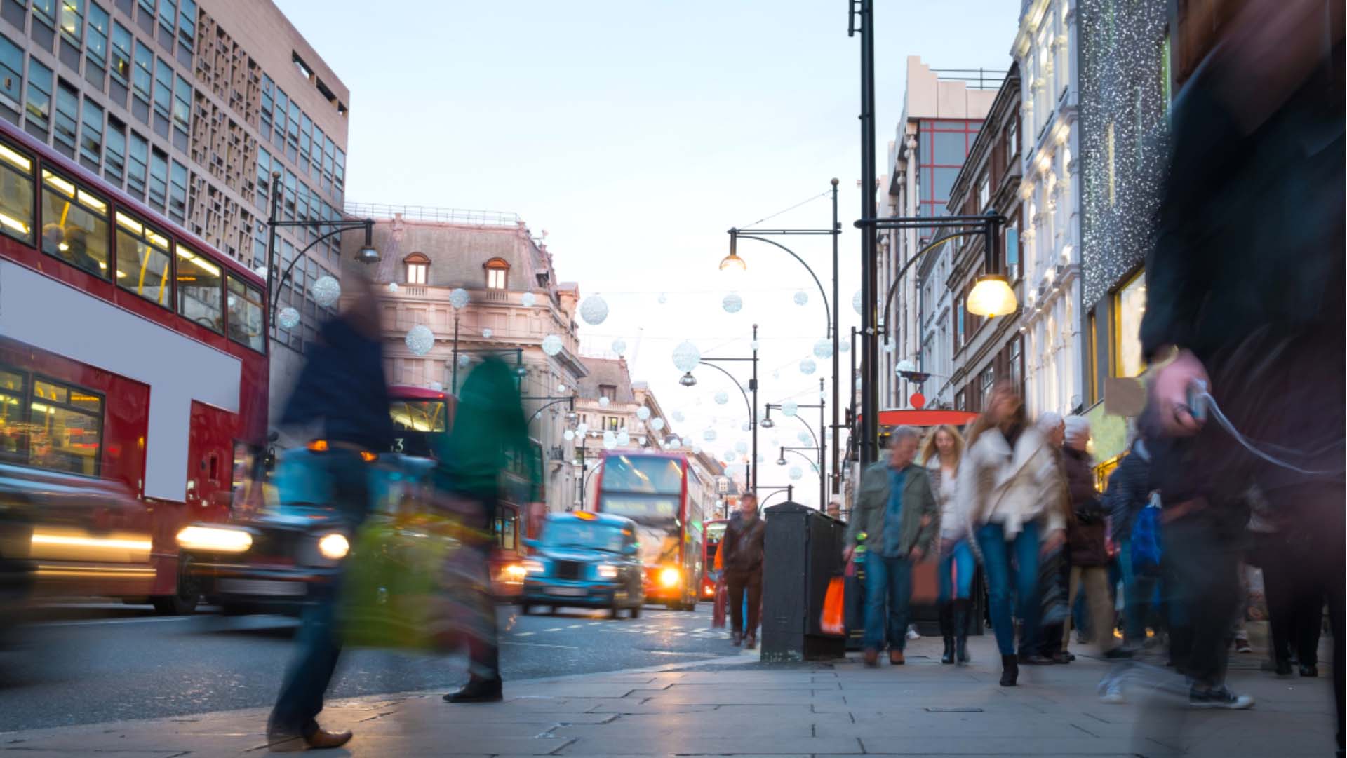 A busy street full of people walking