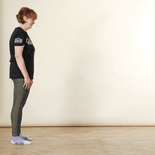 A woman demonstrating an inchworm exercise