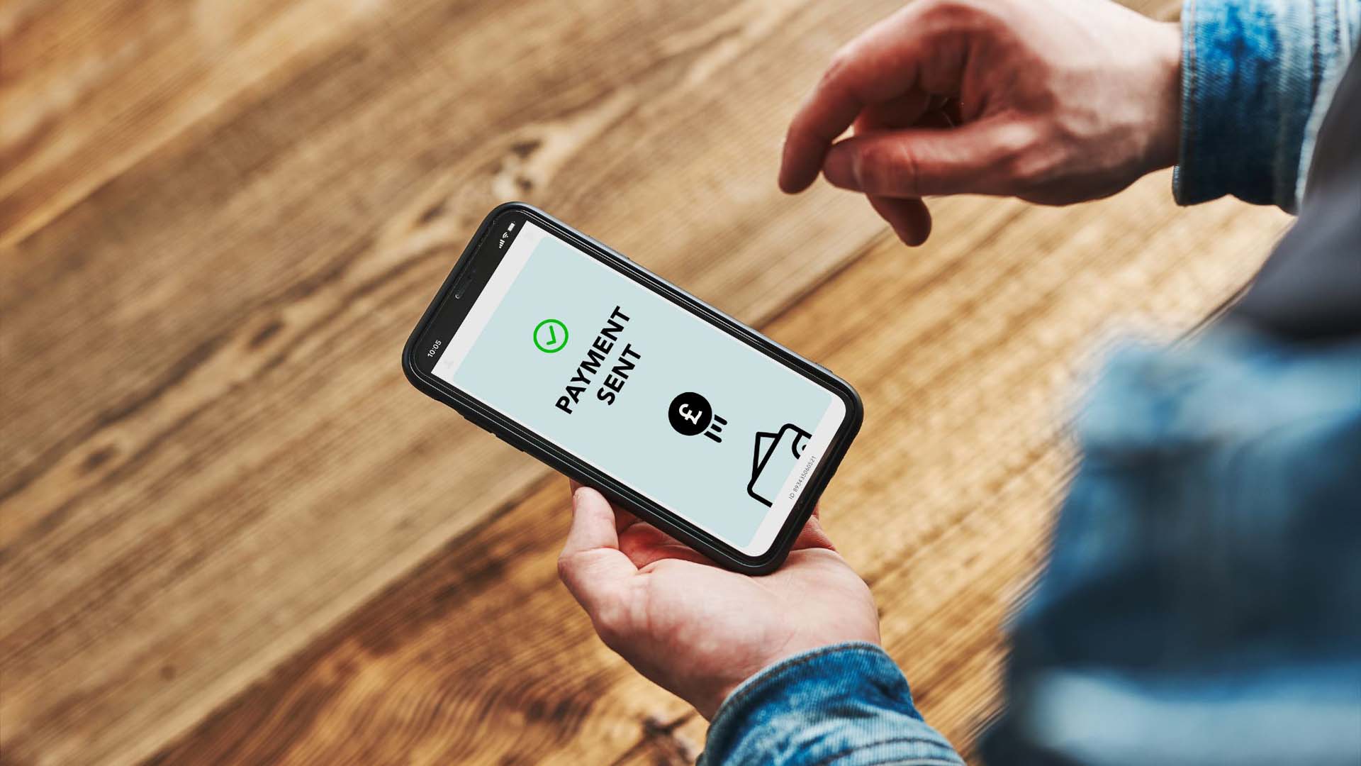 man making a payment via mobile phone