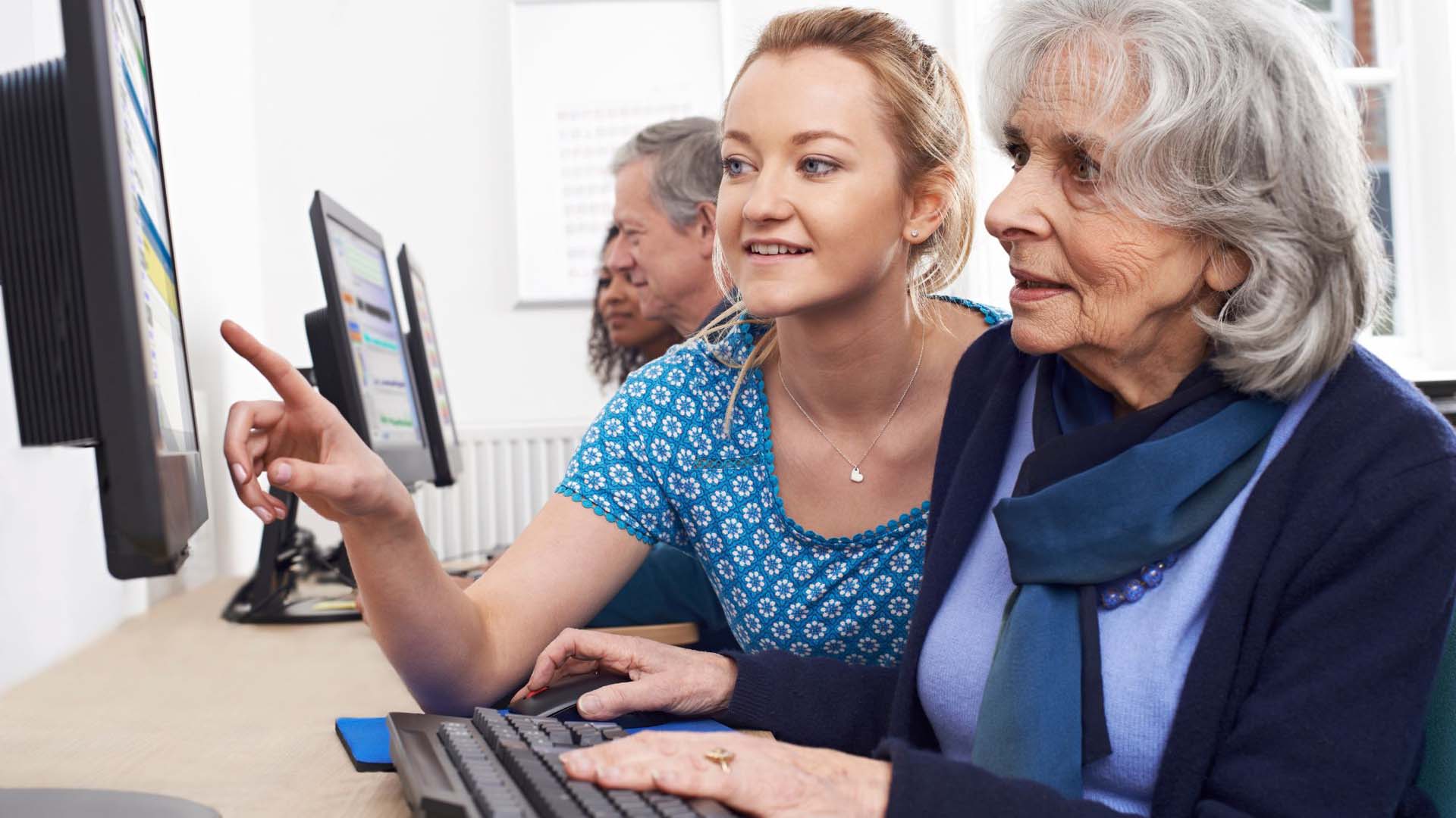 mature lady having a computer lesson