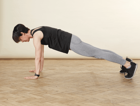 A woman demonstrating how to do push ups