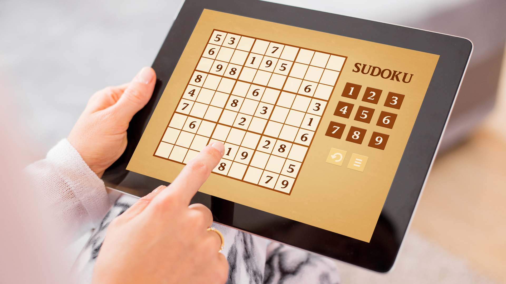 person playing sudoku on their ipad