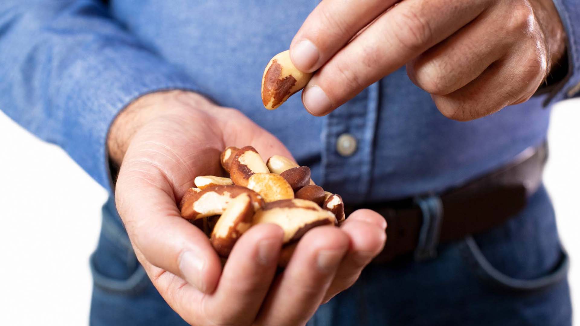 a man with some brazil nuts in his hand
