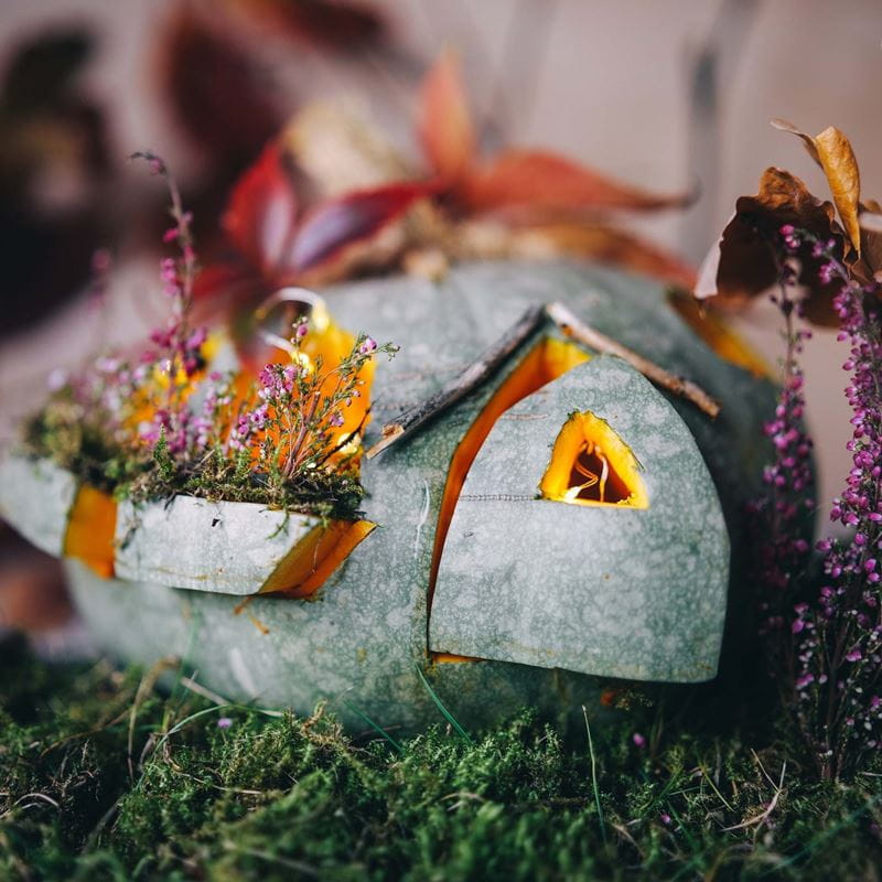 a pumpkin carved to look like a cottage