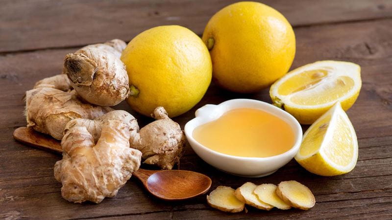 Lemon, honey and ginger set out on the table ready to mix