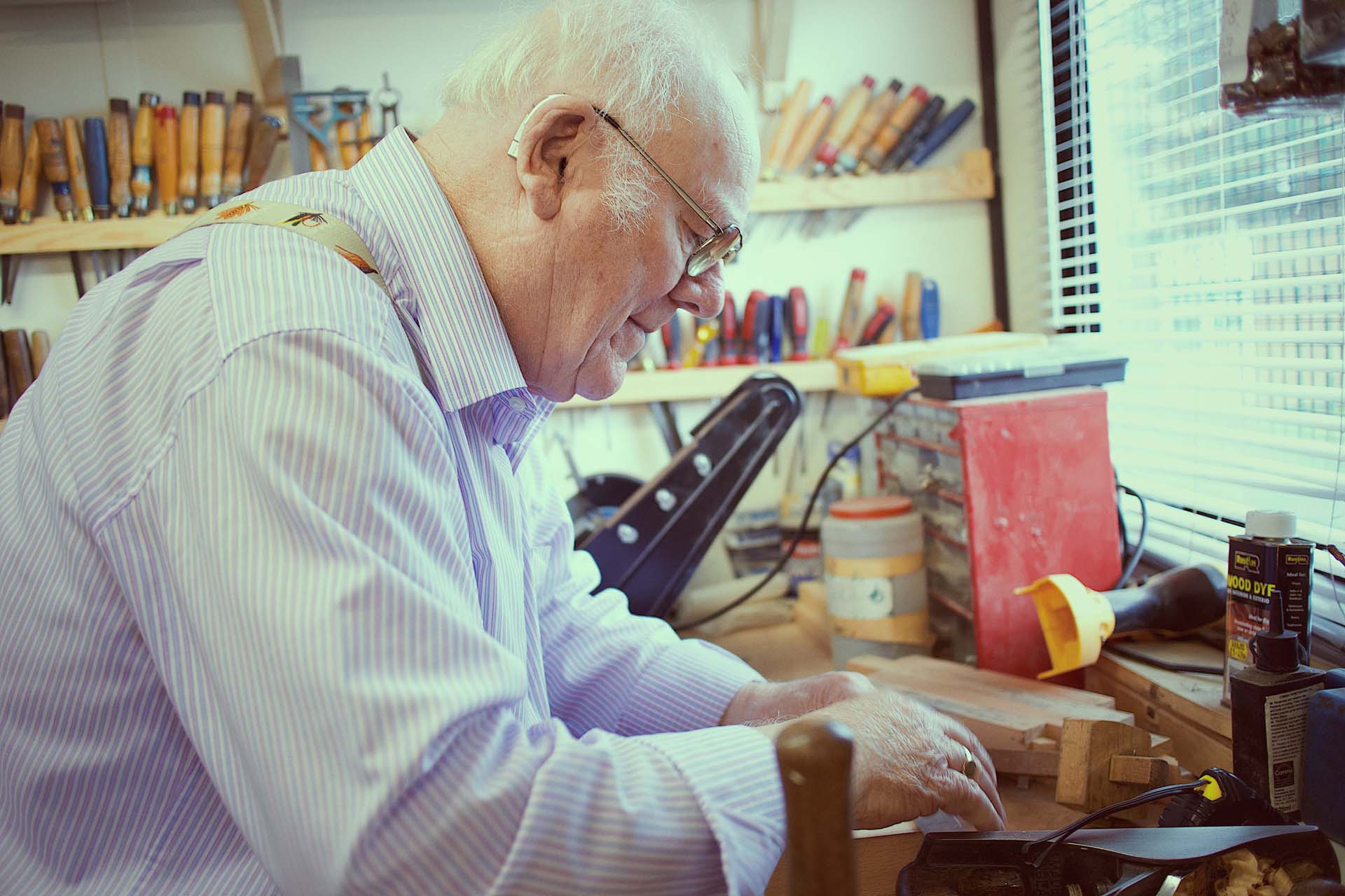An older man working in his shed