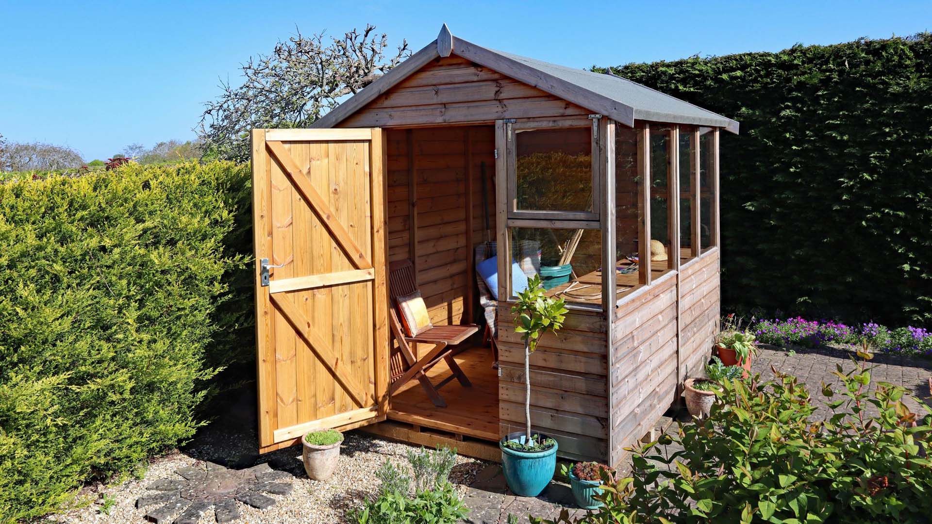 Open garden shed at the corner of the garden