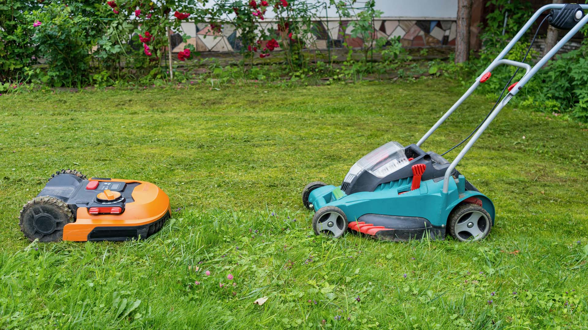 Two types of battery powered and cordless machinery in a grass area