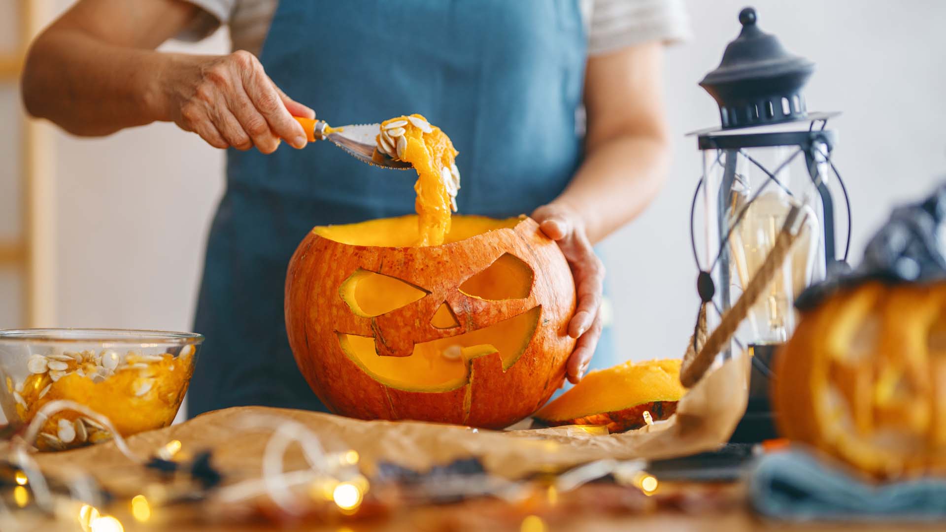 A carved pumpkin being scooped out