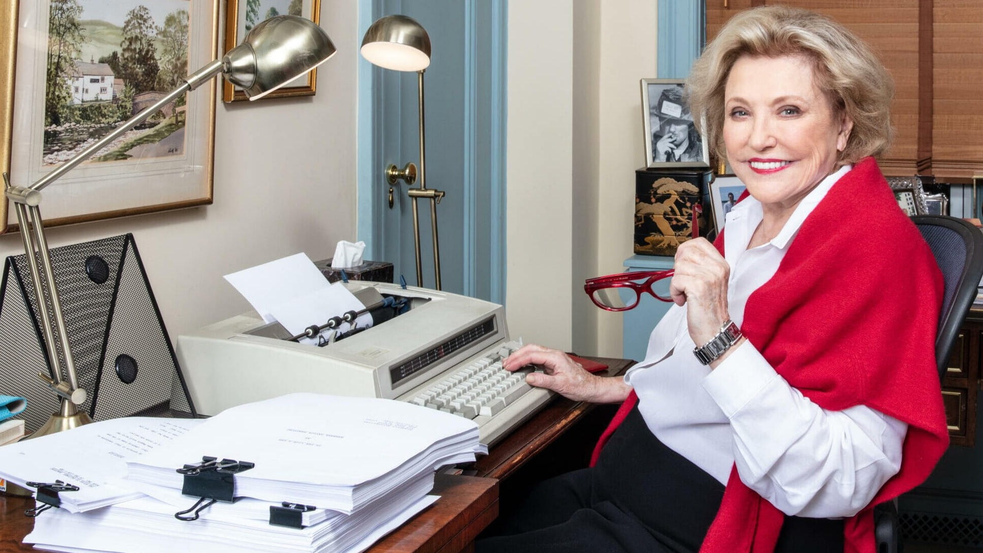 Barbara Taylor Bradford sat at her desk and typewriter