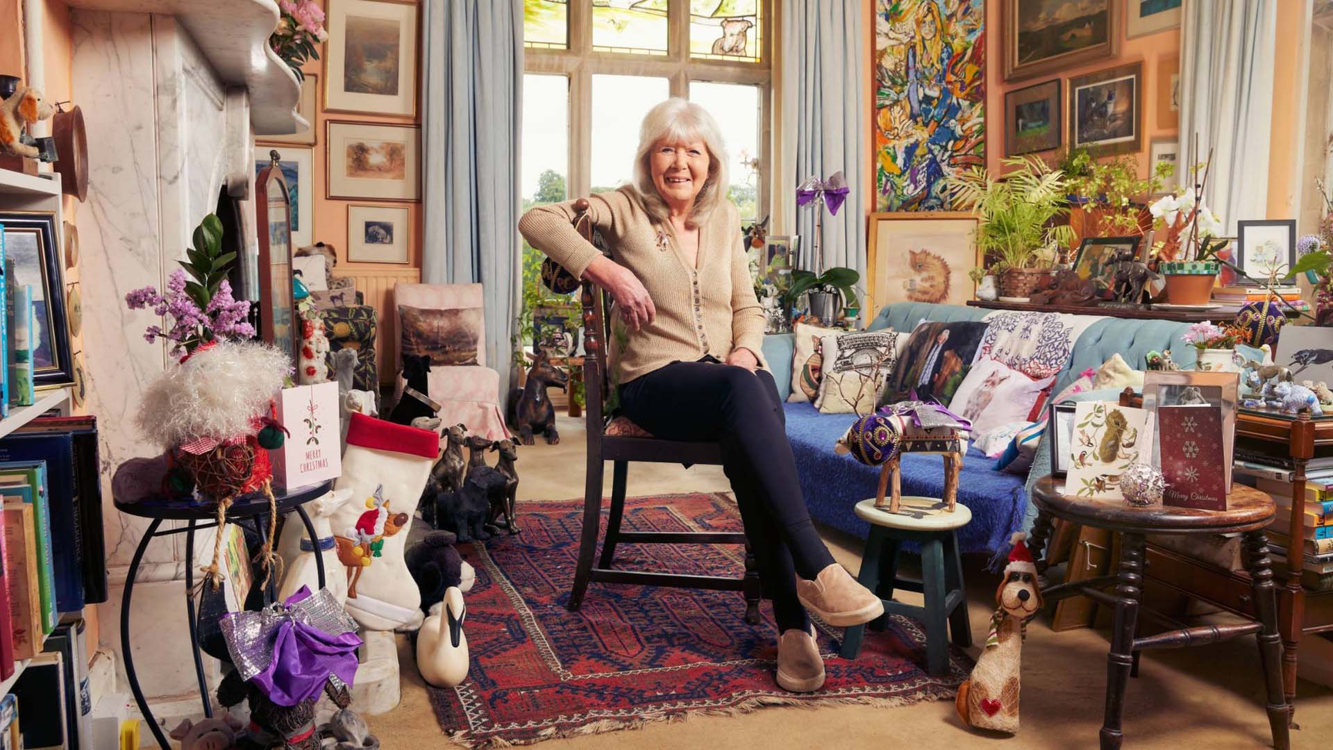 Jilly Cooper sat in her living room