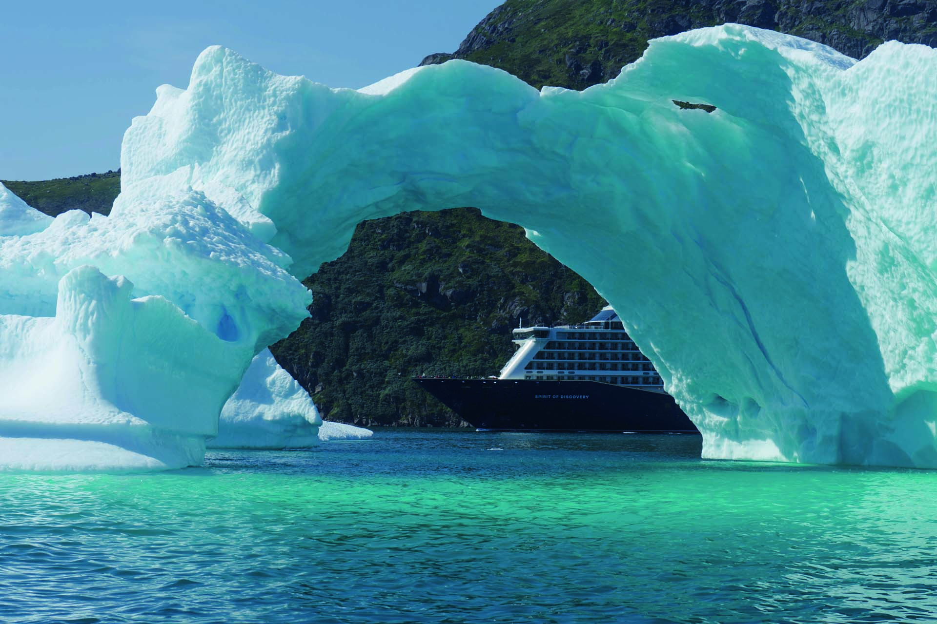 A cruise ship sailing behind an ice floe