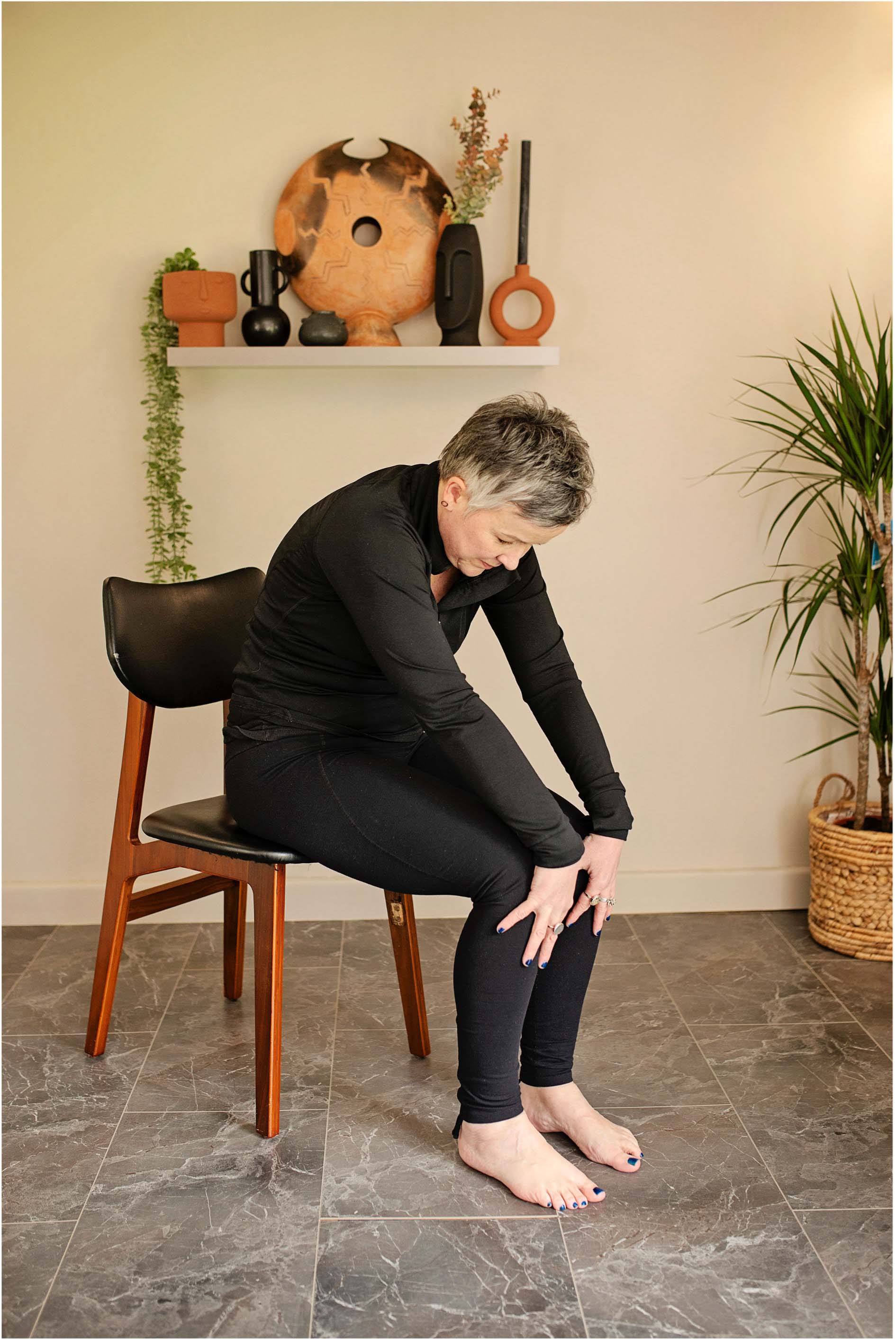 Demonstrating sitting cat-cow position