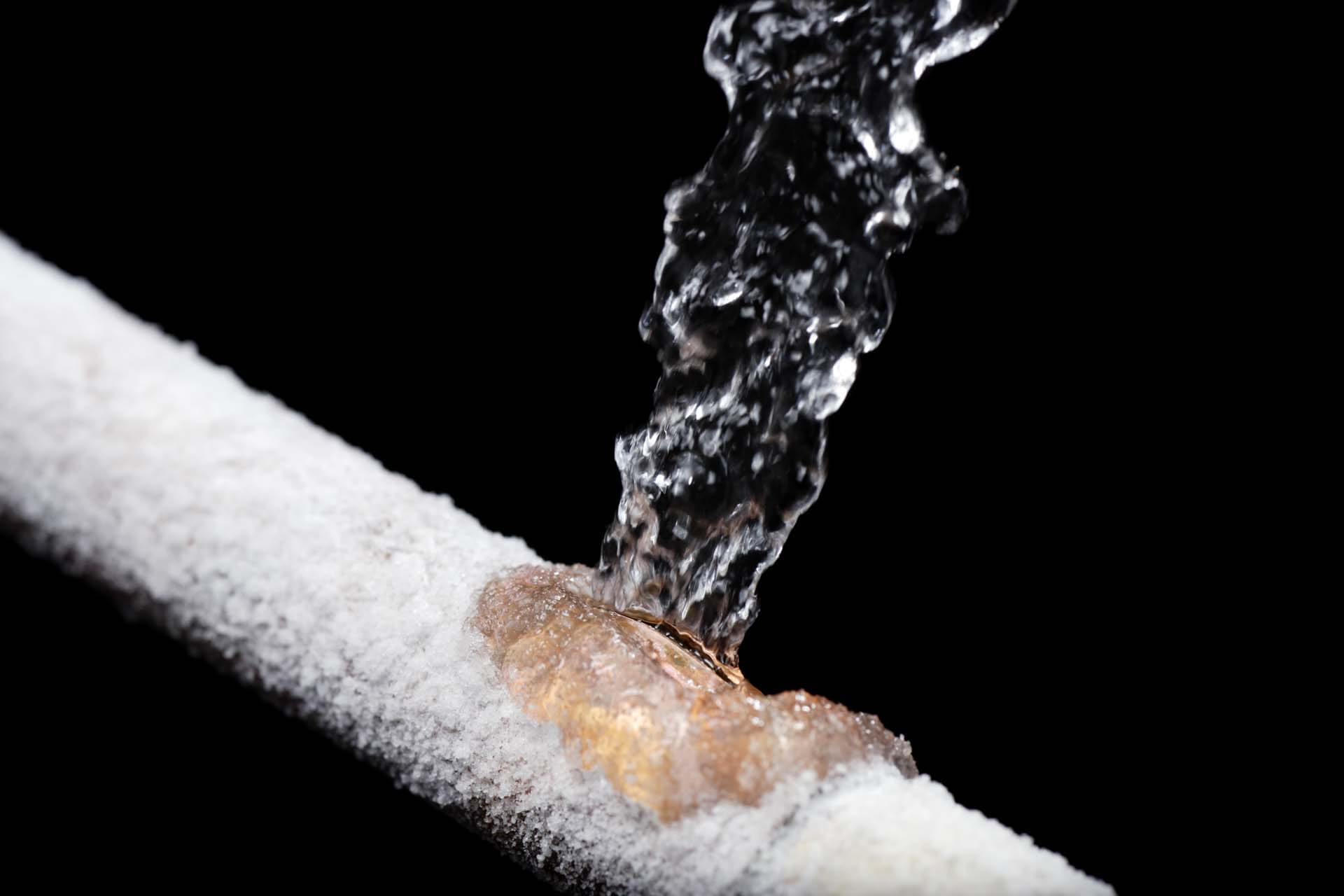 Water being poured on frozen pipes