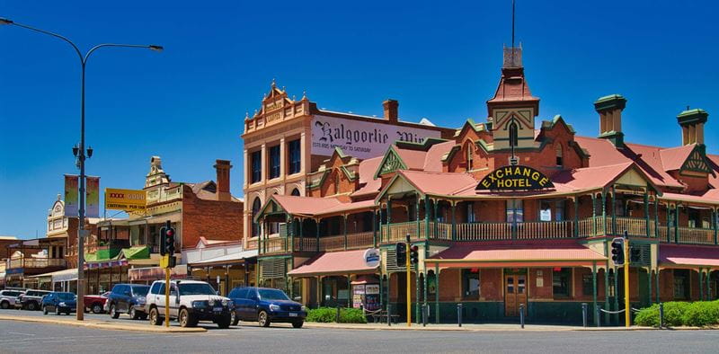The front of old style buildings in a New Zealand town with blue sky behind