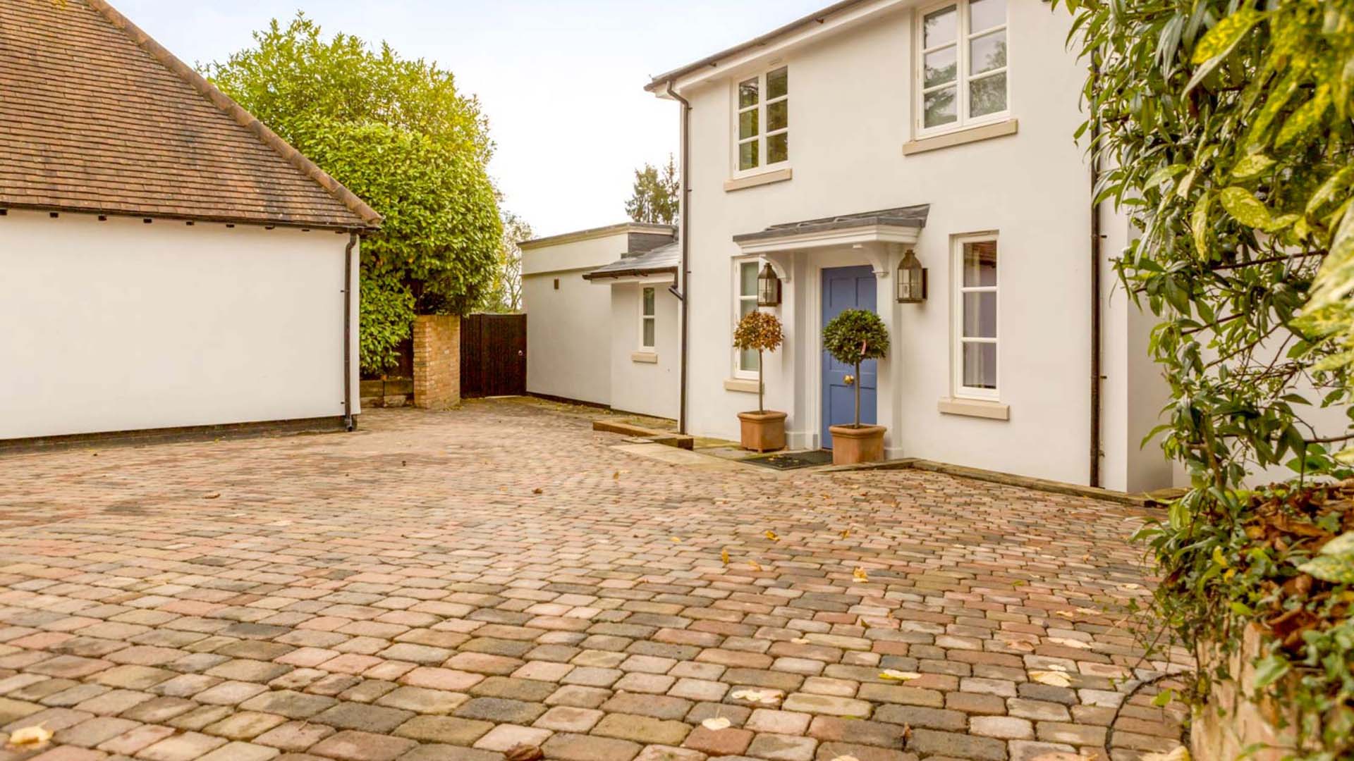 A white house with double garage to the left 