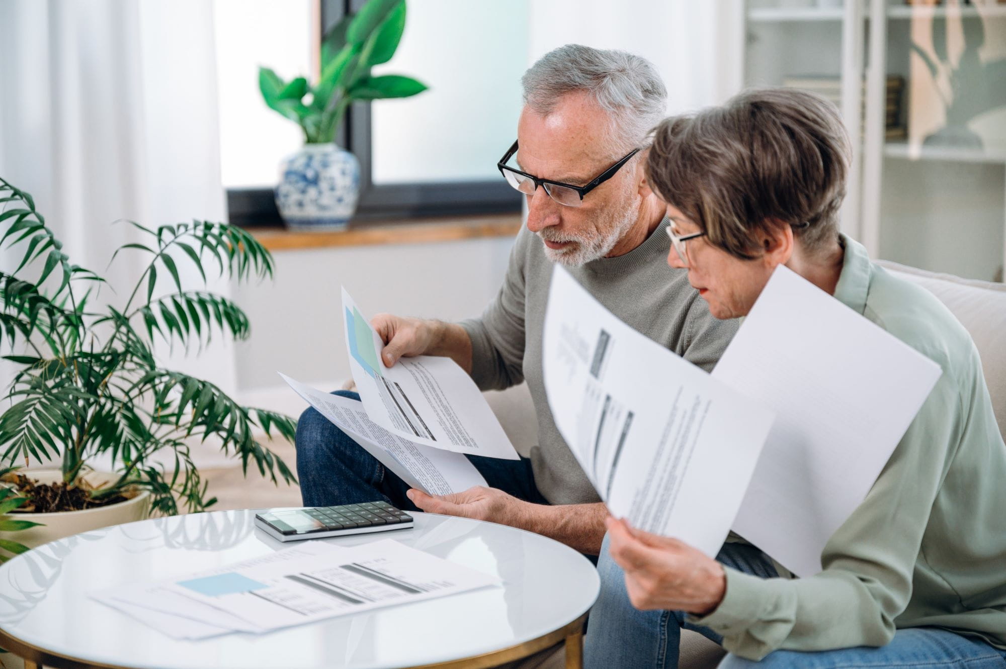 couple looking through their bills at the coffee table