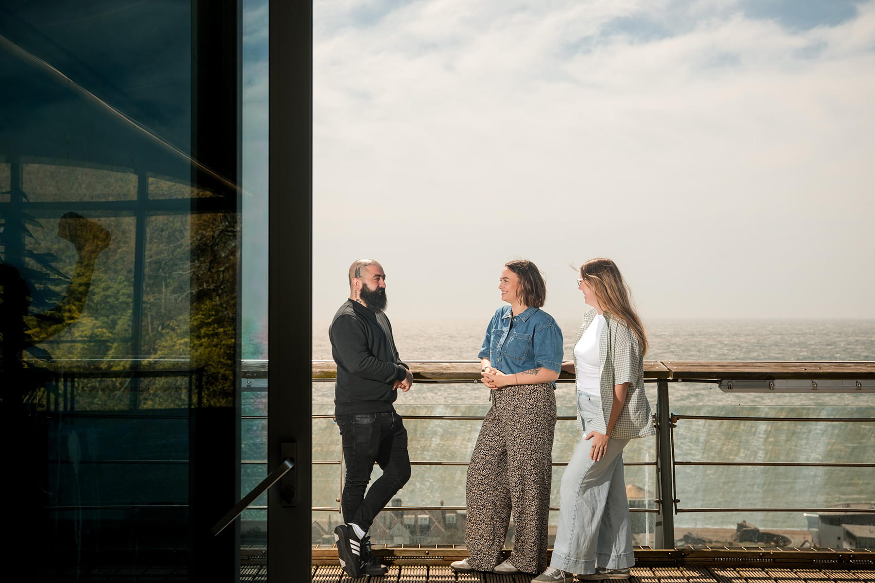 Three people on terrace at Saga Enbrook office