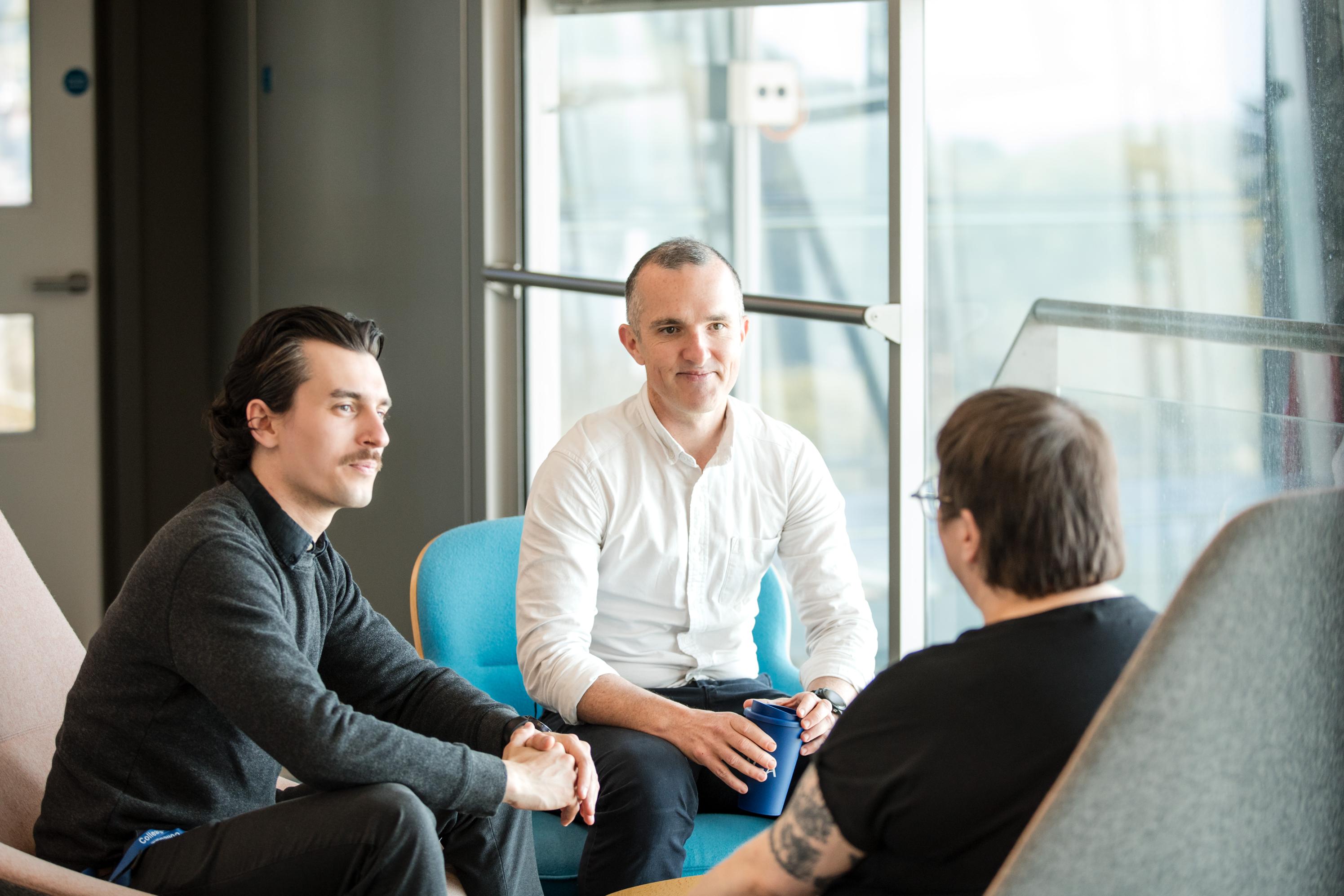 Three people in a meeting