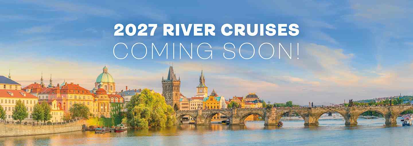 A scenic riverside view of a historic European city and the text ‘2027 River Cruises Coming Soon!’ displayed across the sky.