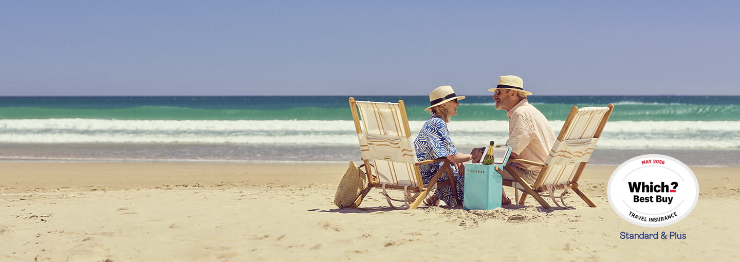 Two people sitting in deck chairs on a sandy beach beside the sea, with a Which? Best Buy logo in the corner.