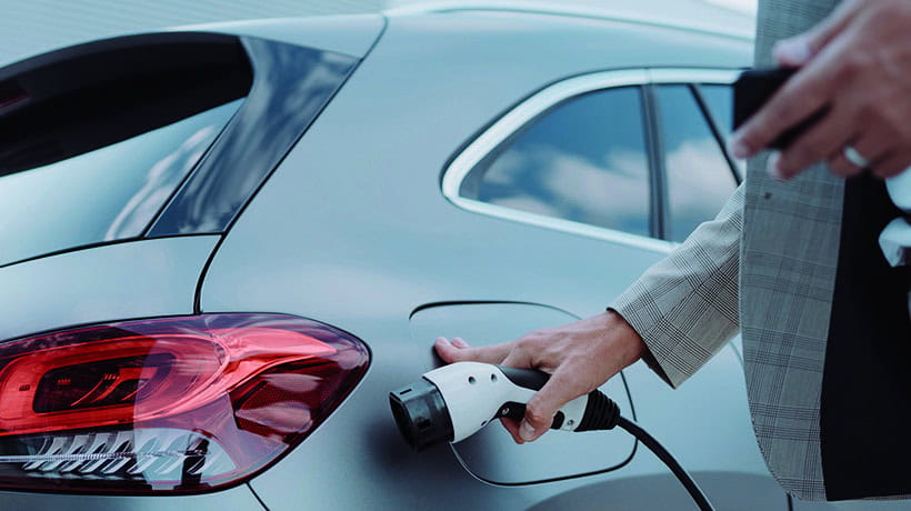 Close up of a car charger about to be plugged in