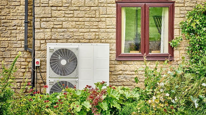 An Electric heat pump on the side of a domestic house
