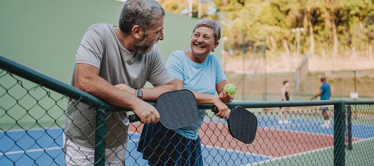 Senior couple take break from pickleball game