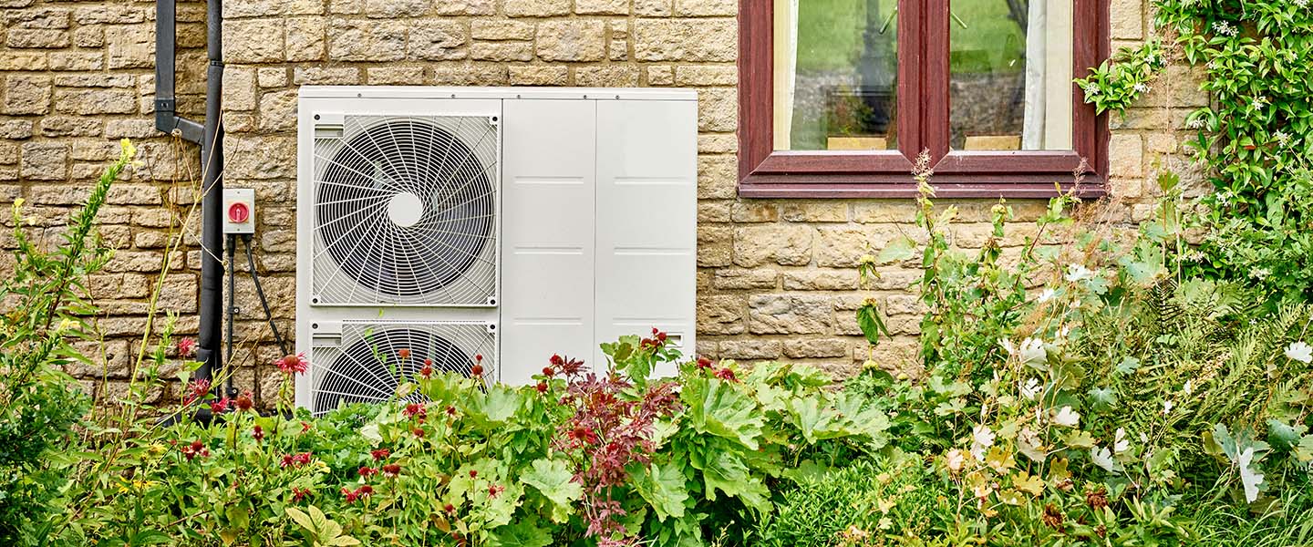 An Electric heat pump on the side of a domestic house