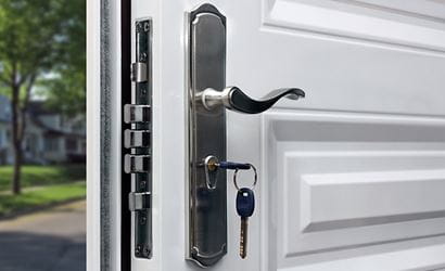 Close-up of the multipoint locking system with keys on a front door.