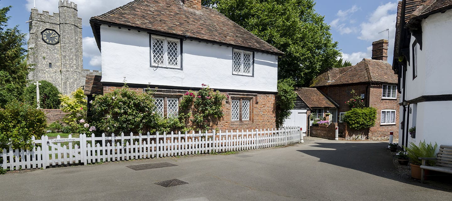 Cottage in the pretty village of Chilham, Kent, UK with the church tower in the background