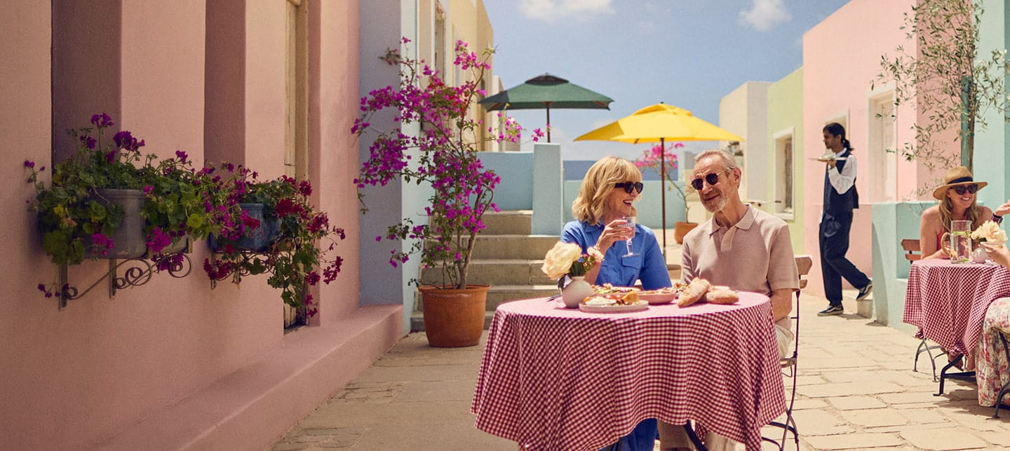 A mature couple dining alfresco on a beautiful sunny day while on holiday. 