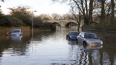A Spring high tide floods a Richmond street leaving cars waterlogged.