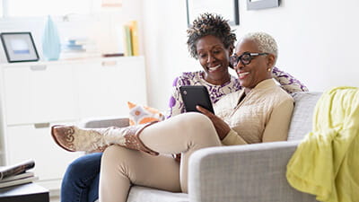 Two women looking at a tablet computer together