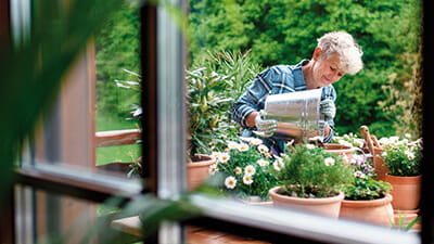 A woman potting plants on her garden table