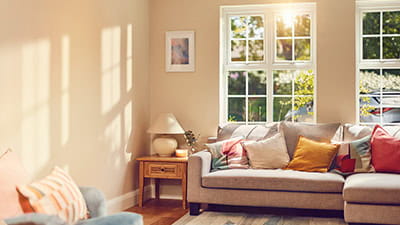 The living room of a modern house on a sunny day.