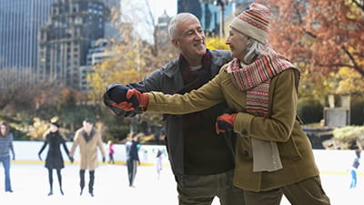 A senior couple ice skating in New York