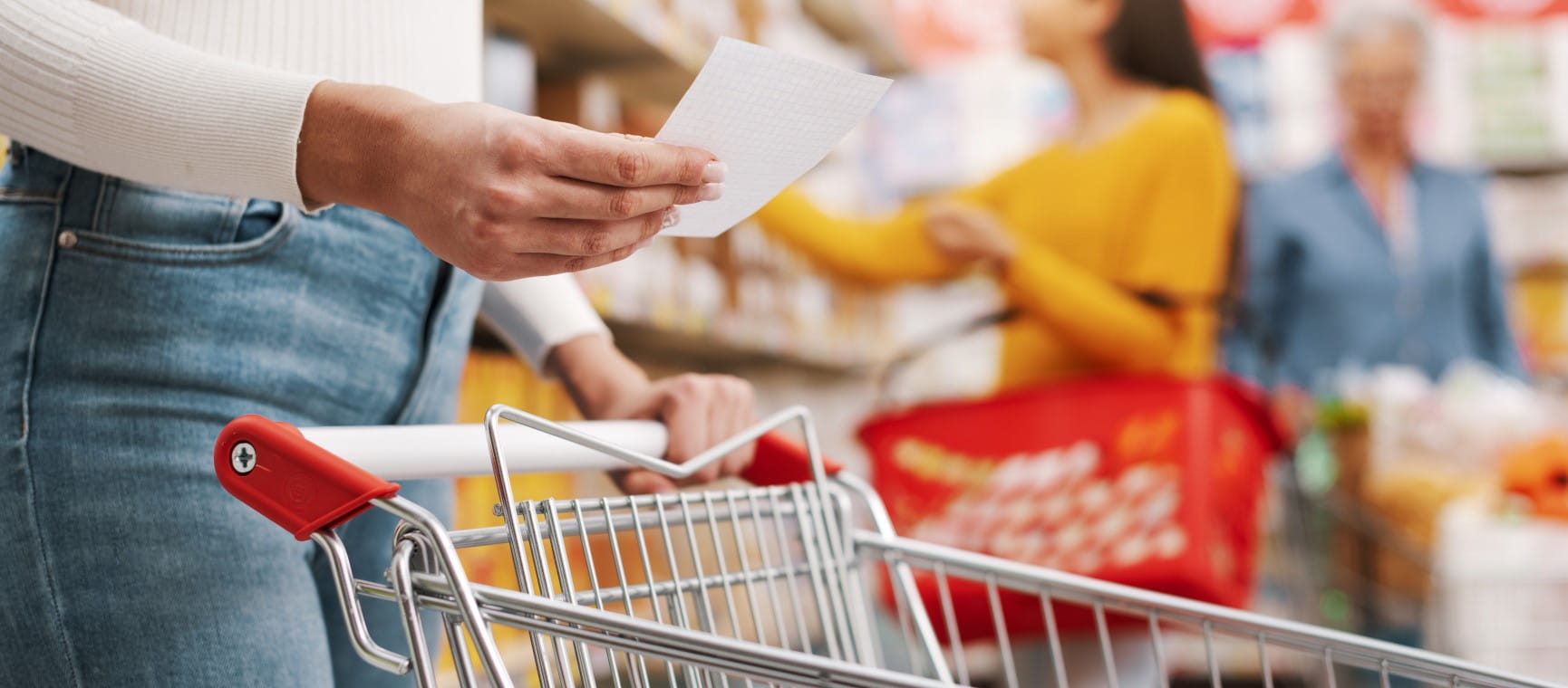 A woman uses the list of best products to buy at Lidl to do her weekly shop | Getty/demaerre