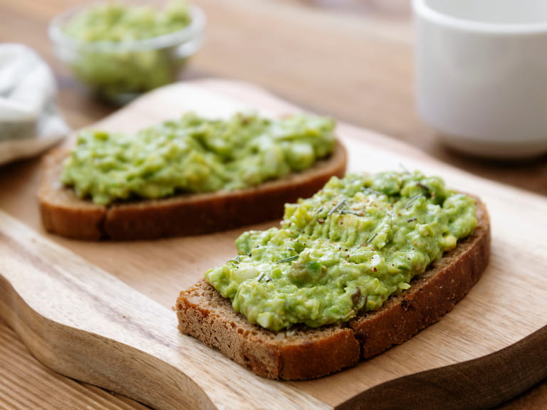 Two slices of toast topped with smashed avocado