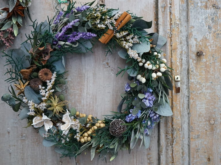 A wreath made of foliage and dried flowers