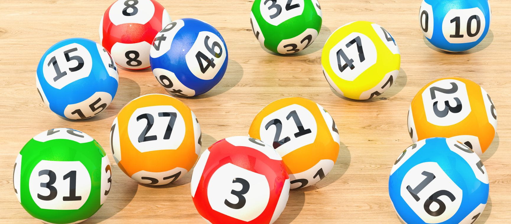 Brightly coloured lottery balls on a wooden surface