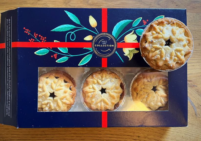 a box of marks and spencer collection mince pies on a wooden table top