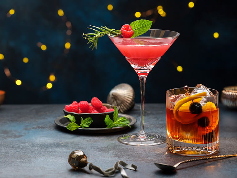 A cosmopolitan cocktail and an old fashioned