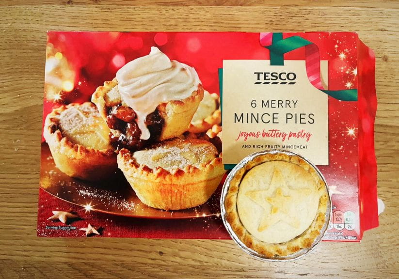 A box of Tesco mince pies on a wooden table top